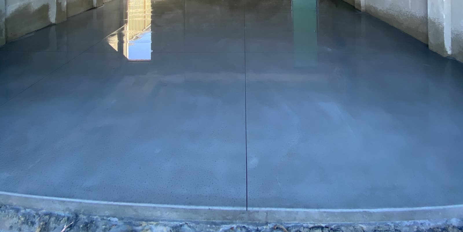 Concrete shed slab poured and cured, ready for the frame
