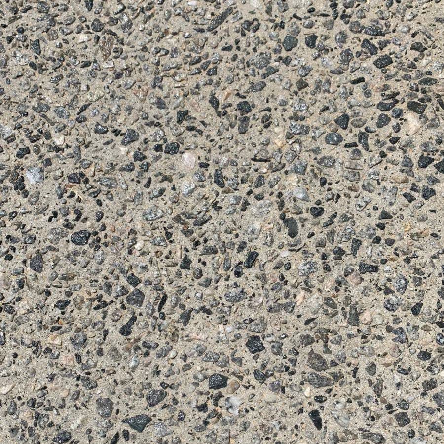 Exposed aggregate stone revealed after washing off, sealed after cure